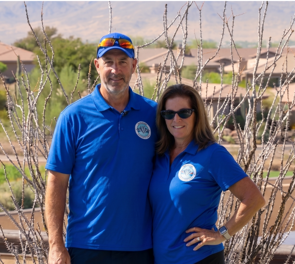 Brian and Shari, owners of Diamond Pool Cleaning, standing in front of their service truck in an Arizona neighborhood.